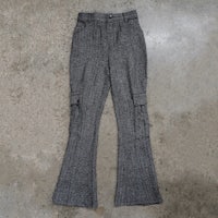 a pair of grey tweed pants on a concrete floor