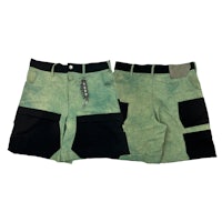 a pair of green and black shorts with pockets