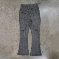 a pair of grey pants on a concrete floor